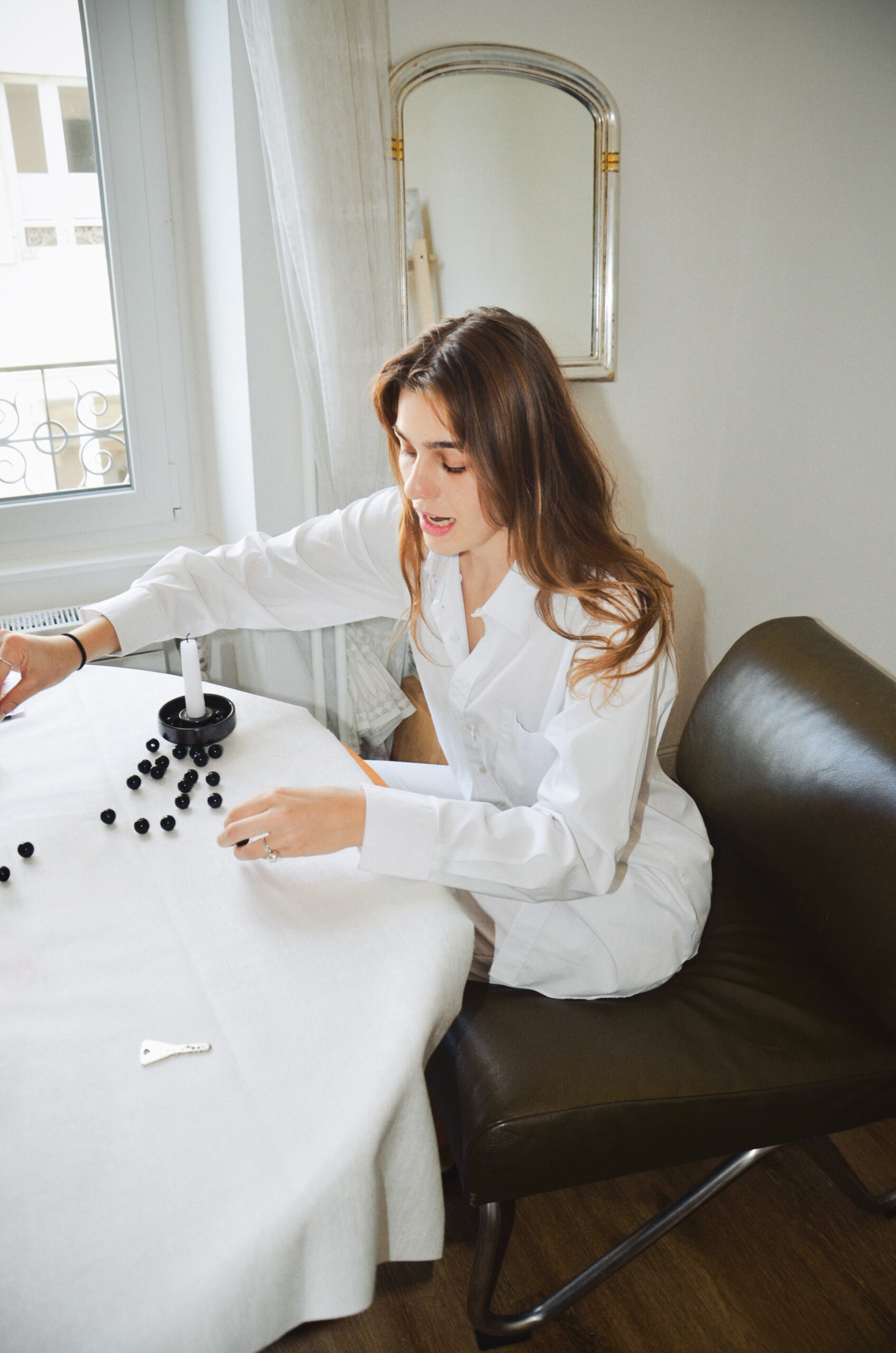 young woman spilling beads on table